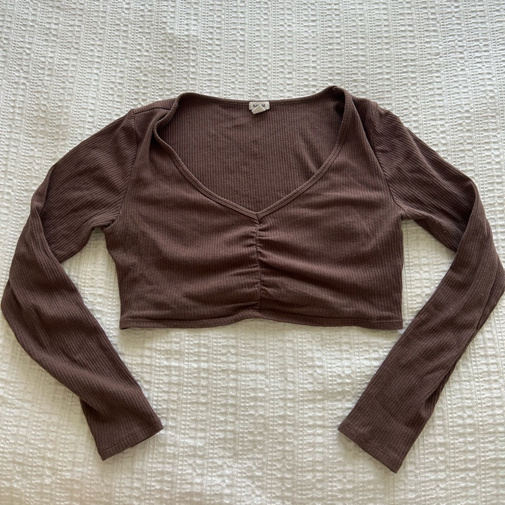 Garage long sleeve crop top in size medium and in the colour brown.